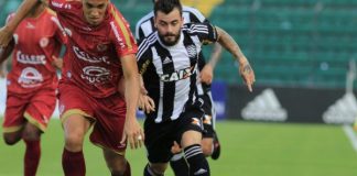 Jogadores de Figueirense (preto e branco) e Hercíllio Luz (vermelho) disputam a bola em direção à câmera