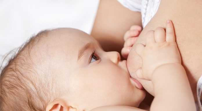 criança recém nascida mama no seio da mãe