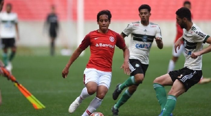 três homens jogando futebol