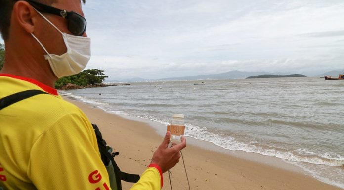 bombeiro faz coleta de água em praia para verificar índice de poluição nos pontos do litoral